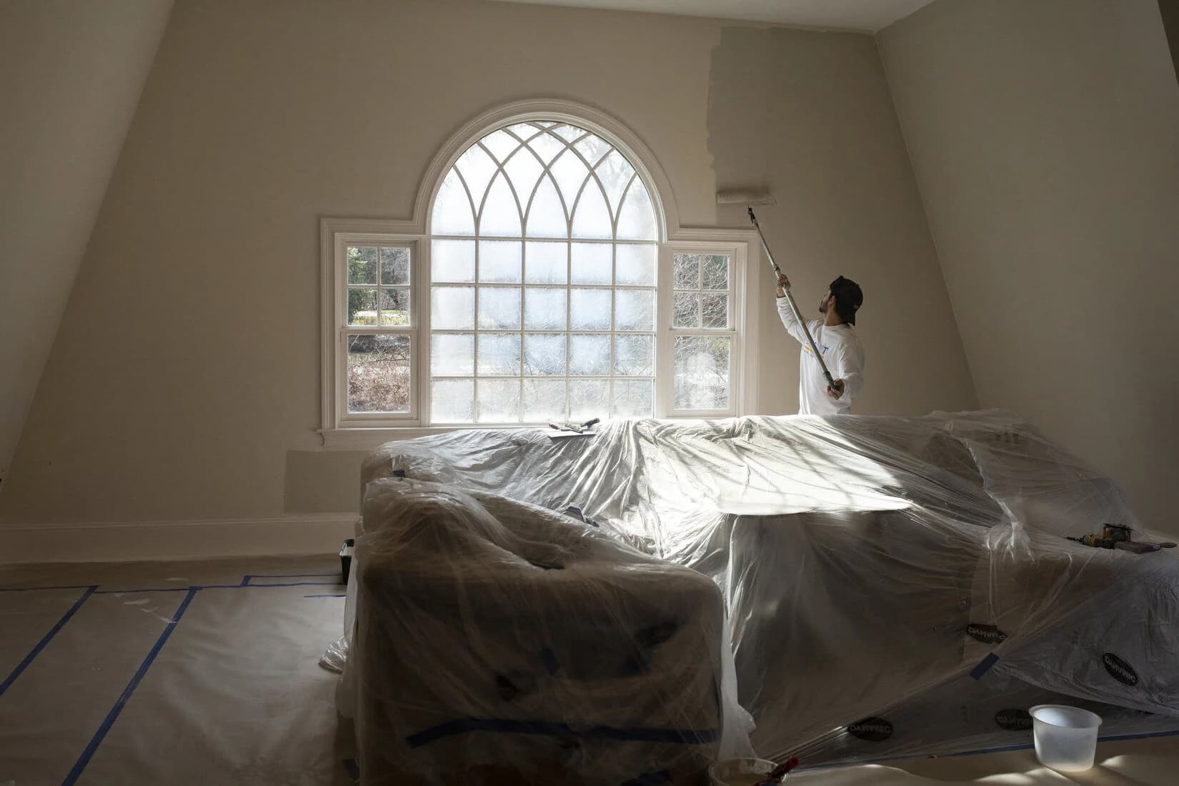 Tri City Painter rolling the interior wall of a residential home in Kitchener