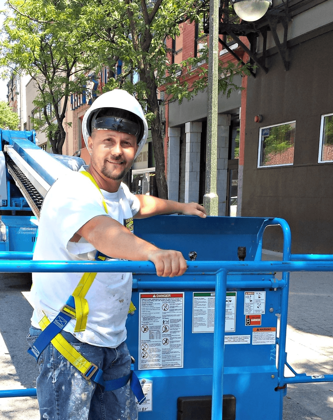 Tri City Painters employee in a lift at a job site in Kitchener, Ontario