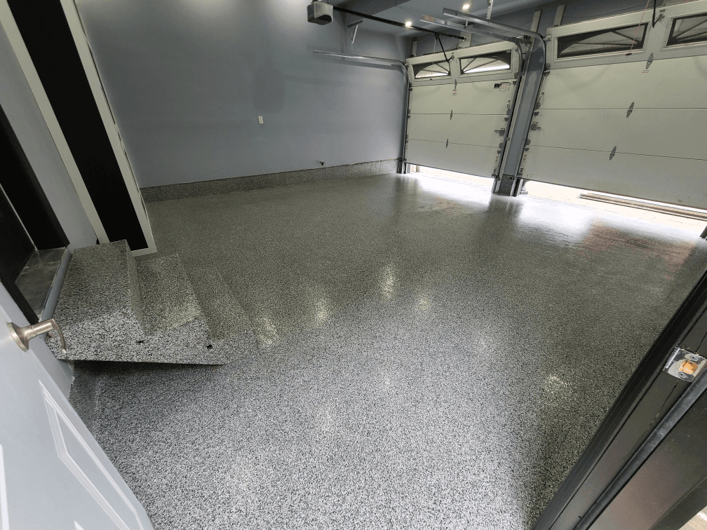 Freshly coated flake epoxy garage floor in a residential home in Kitchener, Ontario