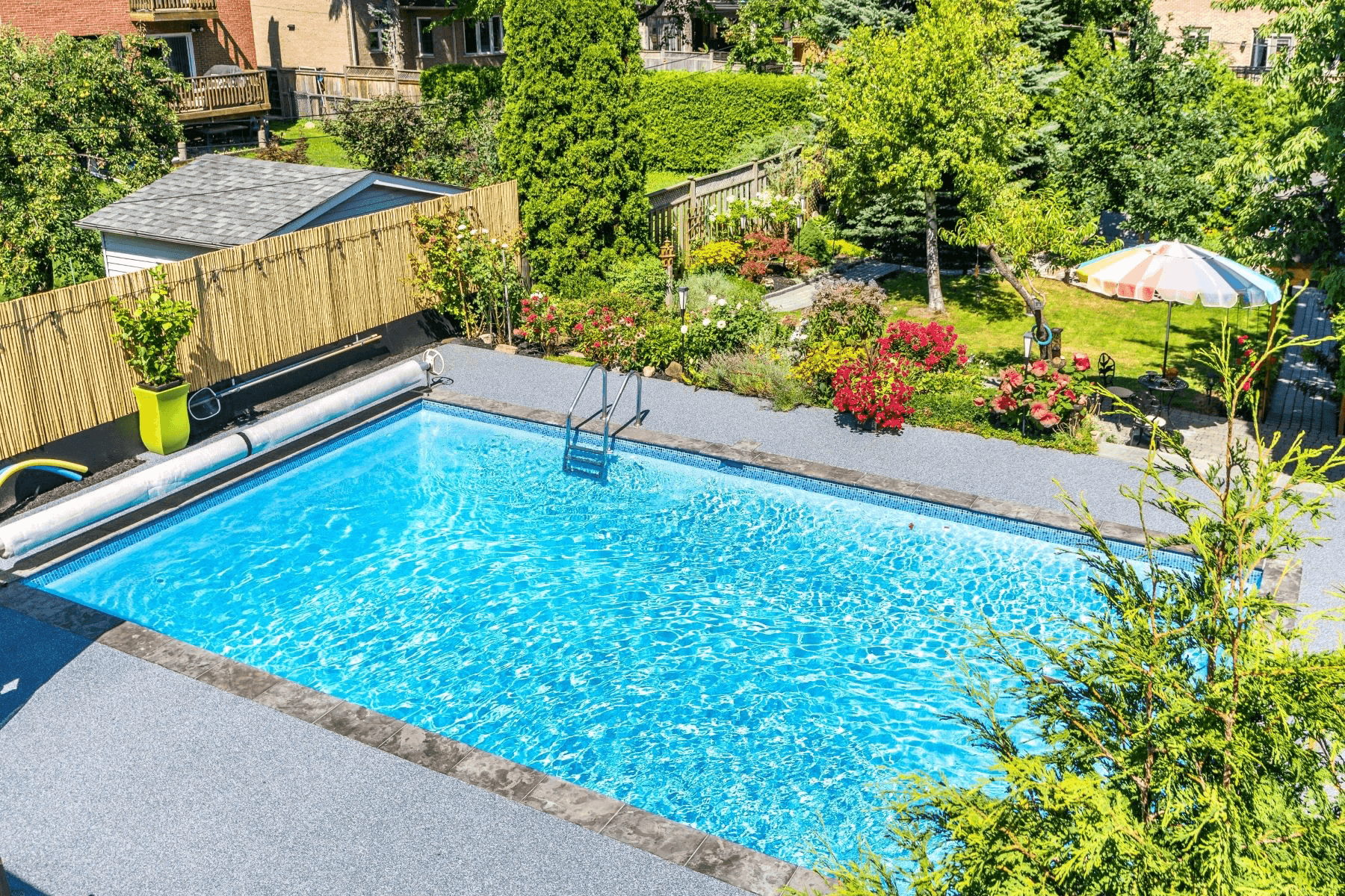 Rubberkrete soft rubber resurfacing applied around an inground pool in a Kitchener, Ontario backyard