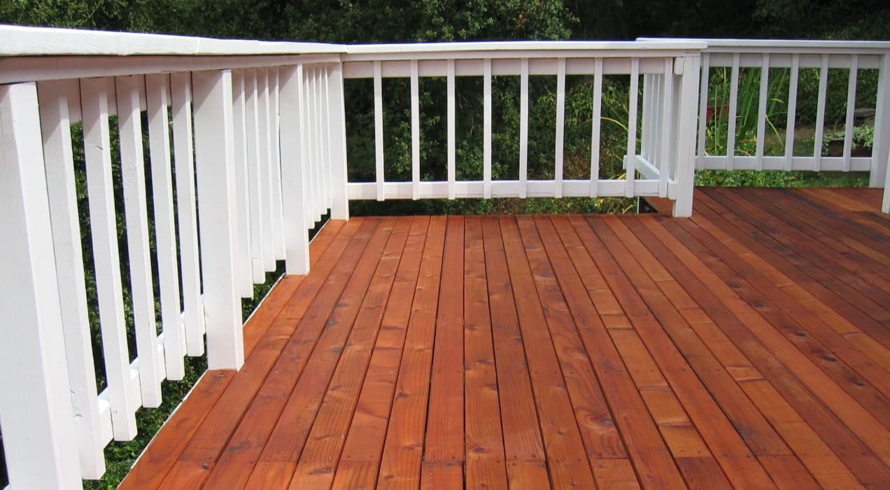 White railing and wooden deck professionally stained by Tri City Painters in Kitchener Ontario